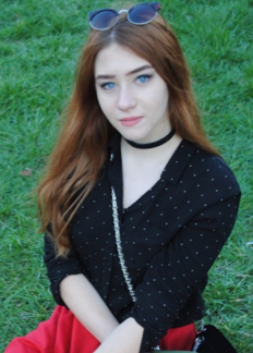  girl-in-sunglasess-black-t-shirt-brown-hair-black-amulet